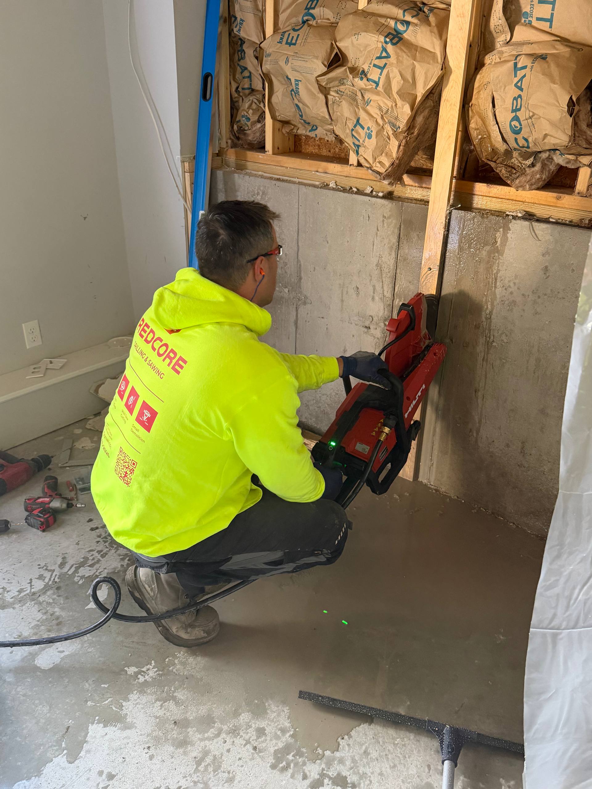 Hand saw cutting concrete wall